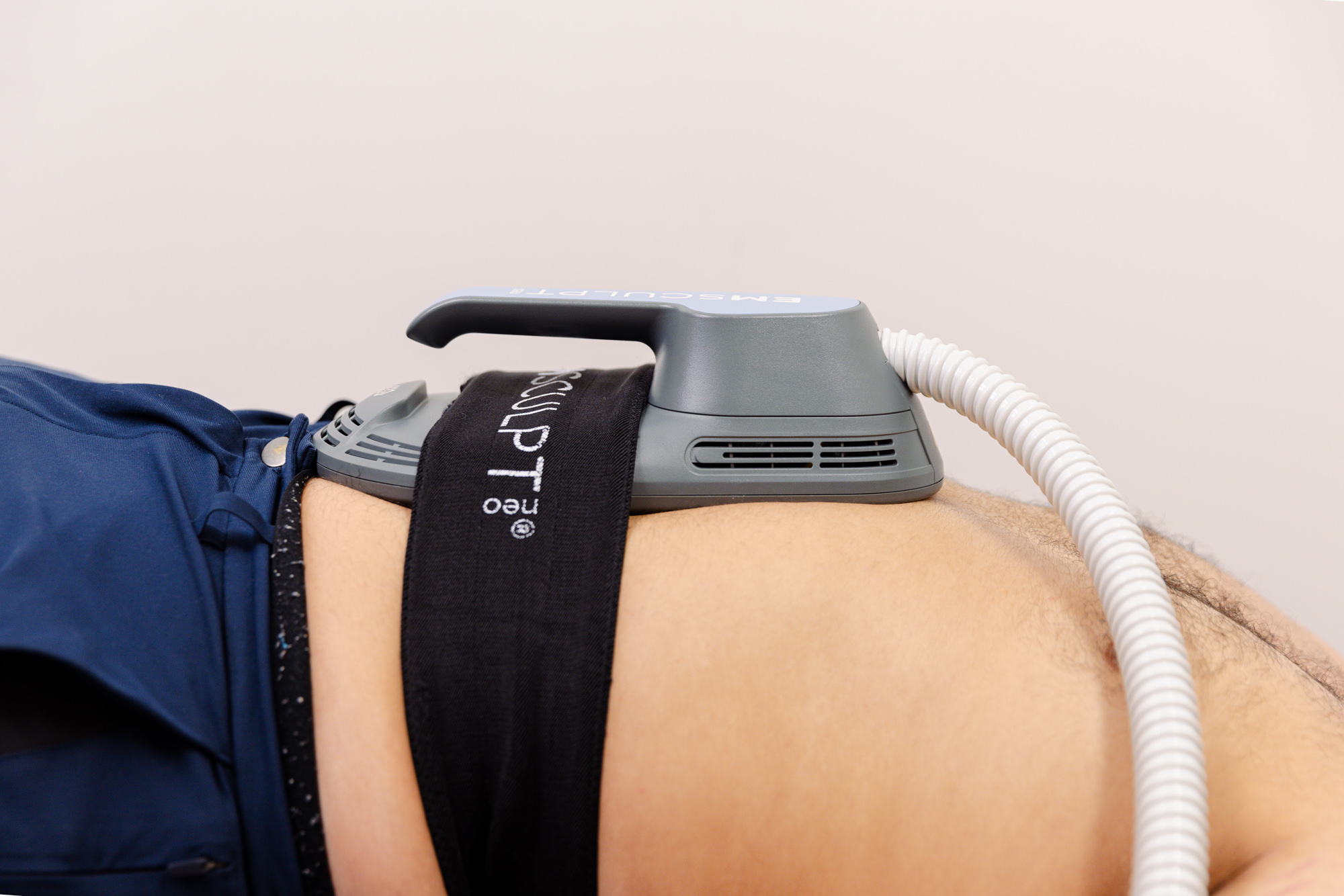 A patient undergoes Emsculpt NEO treatment on their abdomen at our med spa for weight loss in Lenexa.