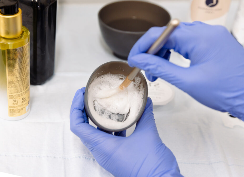 A provider at Physician Aesthetic Specialists prepares a facial formula to use for an acne treatment in Lenexa.