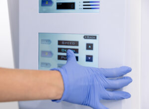 A provider wearing blue gloves prepares to perform a treatment with Scarlet RF in Lenexa.