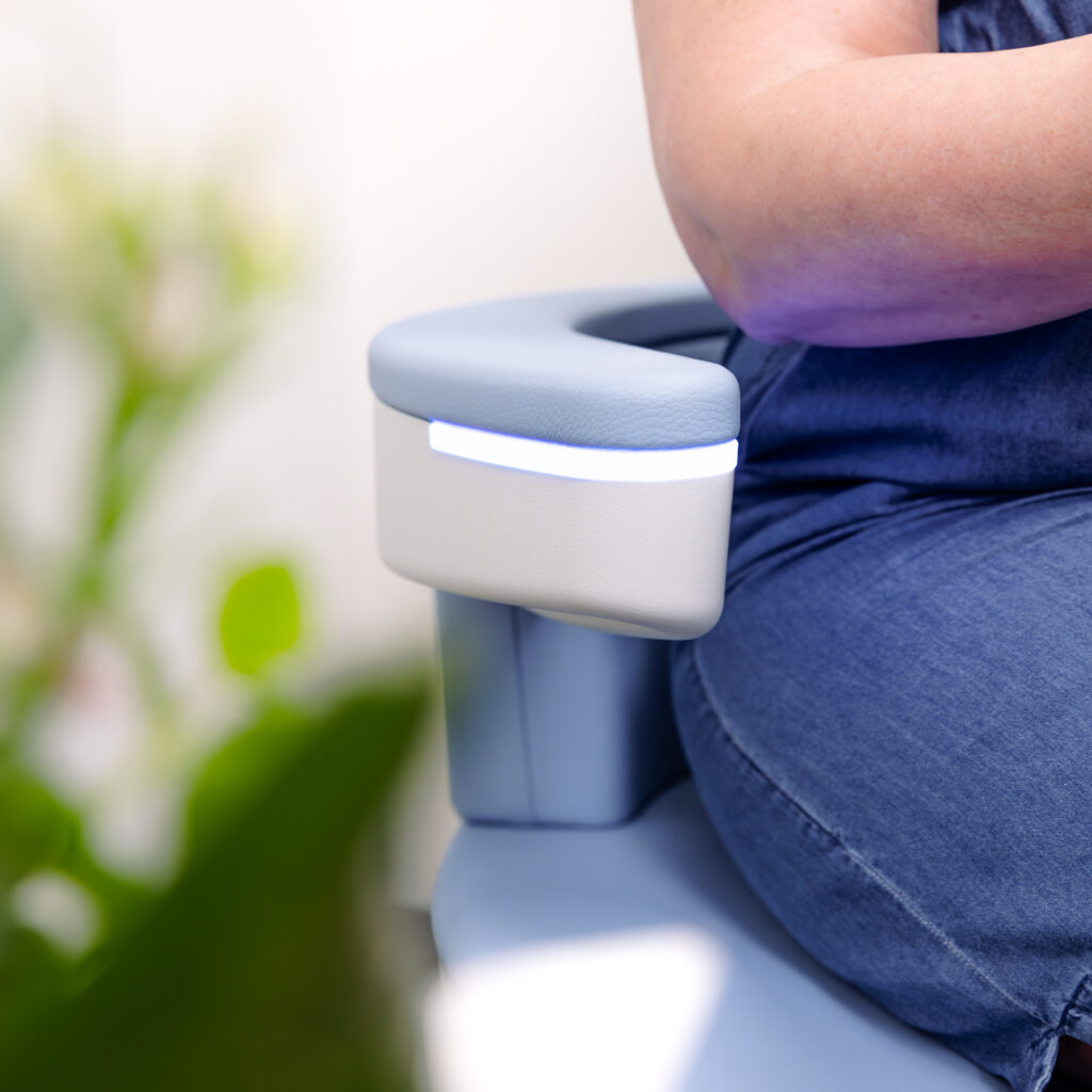 A patient comfortably sitting on our Emsella chair for her incontinence treatment near Overland Park.