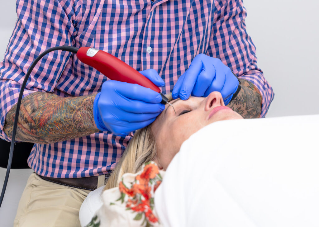 A provider uses Plasmage to perform an under eye lines treatment in Lenexa