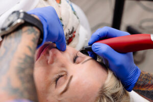 A patient relaxes while a provider performs an under-eye bags treatment in Lenexa.