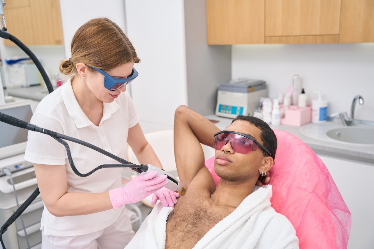 Laser hair removal treatment being performed on a patient's underarm