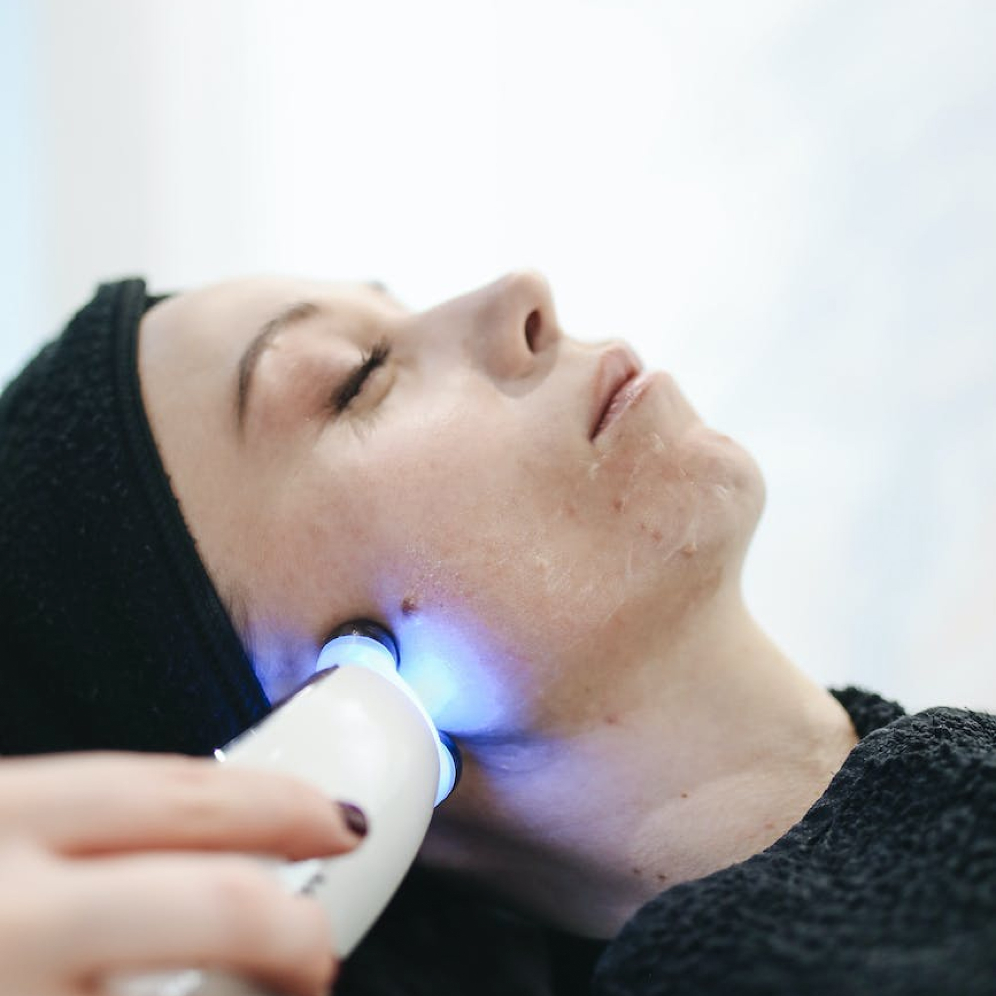 Handheld aesthetic treatment device being used for skin rejuvenation